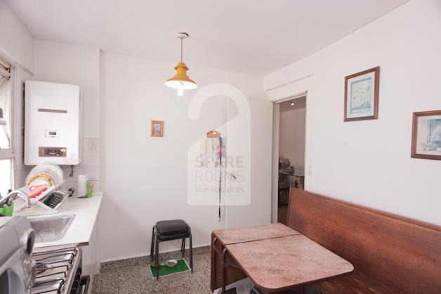 Another view of the dining area and the kitchen.